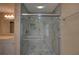 Updated bathroom features a glass-enclosed shower with tiled walls and flooring at 535 Toonigh Rd, Woodstock, GA 30188
