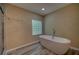 Serene bathroom with standalone tub, glass block window, and updated fixtures at 535 Toonigh Rd, Woodstock, GA 30188