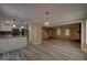 Dining area offering views of the kitchen and living room, modern flooring, and stylish light fixture at 535 Toonigh Rd, Woodstock, GA 30188