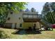 Back of the house features an elevated deck with stairs, yard and convenient basement access at 535 Toonigh Rd, Woodstock, GA 30188