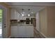 Spacious kitchen featuring granite countertops, stainless steel appliances, and stylish pendant lighting at 535 Toonigh Rd, Woodstock, GA 30188