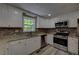 Updated kitchen featuring white cabinets, stainless steel appliances, granite counters and tile backsplash at 535 Toonigh Rd, Woodstock, GA 30188