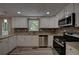 Well-lit kitchen featuring white cabinets, stainless steel appliances, tile backsplash, and granite counters at 535 Toonigh Rd, Woodstock, GA 30188