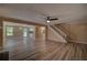 Open living room showcasing modern flooring, ceiling fan, natural light, and seamless flow to other areas at 535 Toonigh Rd, Woodstock, GA 30188