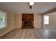 Well-lit living room with brick fireplace, modern flooring, ceiling fan, and ample natural light at 535 Toonigh Rd, Woodstock, GA 30188