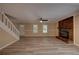Open living room with a brick fireplace, ceiling fan, modern flooring, and lots of natural light at 535 Toonigh Rd, Woodstock, GA 30188