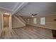 Bright living room with modern flooring, ceiling fan, an open staircase, and great natural light at 535 Toonigh Rd, Woodstock, GA 30188