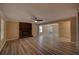 Spacious living room featuring a cozy brick fireplace, modern flooring, ceiling fan, and great natural light at 535 Toonigh Rd, Woodstock, GA 30188