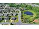 Aerial view of a home with a manicured lawn in a neighborhood near a pond and green space at 7575 Old Camp Lndg, Cumming, GA 30040