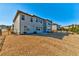A spacious backyard with a patio and two-story house, partially fenced and landscaped on a sunny day at 7575 Old Camp Lndg, Cumming, GA 30040