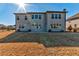The backyard features a patio and grassy area with a two-story house in the background on a sunny day at 7575 Old Camp Lndg, Cumming, GA 30040