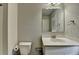 Bathroom featuring a white toilet, vanity, and sink at 7575 Old Camp Lndg, Cumming, GA 30040