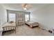 This bedroom is light and bright with carpet and a neutral paint color scheme at 7575 Old Camp Lndg, Cumming, GA 30040