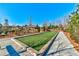 A Bocce Ball Court with a view of a house and playground area in the background on a sunny day at 7575 Old Camp Lndg, Cumming, GA 30040