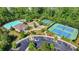 Aerial view of a community pool, playground, tennis courts, and parking area at 7575 Old Camp Lndg, Cumming, GA 30040