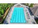 Aerial view of community pool with lounge chairs, surrounded by green space and trees at 7575 Old Camp Lndg, Cumming, GA 30040