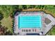 Aerial view of long community pool with lounge chairs and trees with lush green landscaping at 7575 Old Camp Lndg, Cumming, GA 30040