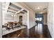 Open-concept view of the dining room showcasing wainscoting and hardwood floors and natural light at 7575 Old Camp Lndg, Cumming, GA 30040