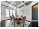 Bright dining area boasting wainscoting, hardwood floors, and a modern chandelier at 7575 Old Camp Lndg, Cumming, GA 30040