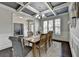 Bright dining area featuring a coffered ceiling and a chandelier at 7575 Old Camp Lndg, Cumming, GA 30040
