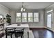 Bright dining room featuring hardwood floors, large windows, and modern decor for elegant meals at 7575 Old Camp Lndg, Cumming, GA 30040