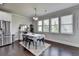 Bright dining room featuring hardwood floors, large windows, and modern decor for elegant meals at 7575 Old Camp Lndg, Cumming, GA 30040
