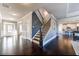 Spacious foyer with hardwood floors, a staircase, and a view into the kitchen at 7575 Old Camp Lndg, Cumming, GA 30040
