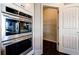 Stainless steel oven next to a pantry with storage shelves provides ample space in this kitchen at 7575 Old Camp Lndg, Cumming, GA 30040