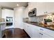Modern kitchen with stainless steel appliances, custom cabinetry, and a sleek design at 7575 Old Camp Lndg, Cumming, GA 30040