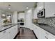 Well-equipped kitchen boasts stainless steel appliances, stylish backsplash, and modern cabinetry for culinary enthusiasts at 7575 Old Camp Lndg, Cumming, GA 30040