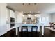 Modern kitchen island with barstool seating, stainless steel appliances, and designer backsplash at 7575 Old Camp Lndg, Cumming, GA 30040