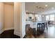 Kitchen features a central island with bar stool seating, stainless appliances, and bright lighting at 7575 Old Camp Lndg, Cumming, GA 30040