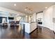 Bright kitchen with island, stainless steel appliances, hardwood floors, and open to the living room at 7575 Old Camp Lndg, Cumming, GA 30040