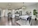 Open concept kitchen and dining area with modern appliances and stylish decor creates a seamless living space at 7575 Old Camp Lndg, Cumming, GA 30040