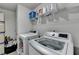 Functional laundry room with washer, dryer, and shelving for storage at 7575 Old Camp Lndg, Cumming, GA 30040