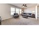 Cozy living room features a comfortable seating area, bright windows, and plush carpeting at 7575 Old Camp Lndg, Cumming, GA 30040
