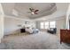 Large main bedroom with trey ceiling, plush carpeting, and plenty of natural light at 7575 Old Camp Lndg, Cumming, GA 30040