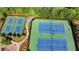 Aerial view of tennis courts with green space and landscaping near a community at 7575 Old Camp Lndg, Cumming, GA 30040