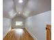 Finished attic with wood floors, a small window, and white walls, featuring recessed lighting at 1120 Arlington Sw Ave, Atlanta, GA 30310