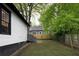 View of the backyard, featuring a wooden fence and mature trees for privacy at 1120 Arlington Sw Ave, Atlanta, GA 30310
