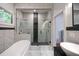 Luxurious bathroom featuring a sleek glass enclosed shower, soaker tub, and modern finishes at 1120 Arlington Sw Ave, Atlanta, GA 30310
