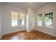 Bright bedroom featuring hardwood floors, white walls, and windows that offer natural light and views at 1120 Arlington Sw Ave, Atlanta, GA 30310