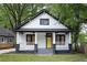 Charming exterior view of a two-story home featuring a welcoming front porch and a bright yellow front door at 1120 Arlington Sw Ave, Atlanta, GA 30310