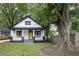 Charming exterior view of a two-story home featuring a welcoming front porch and a bright yellow front door at 1120 Arlington Sw Ave, Atlanta, GA 30310