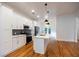 The bright kitchen features white cabinetry, subway tile backsplash, stainless steel appliances, and hardwood floors at 1120 Arlington Sw Ave, Atlanta, GA 30310