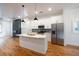 The bright kitchen features an island with a marble countertop, stainless steel appliances, and hardwood floors at 1120 Arlington Sw Ave, Atlanta, GA 30310