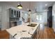 The bright kitchen features an island with a marble countertop, updated cabinets, and a view into the living room at 1120 Arlington Sw Ave, Atlanta, GA 30310