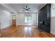 Bright living room with hardwood floors, a black accent wall with fireplace, and natural light from the windows at 1120 Arlington Sw Ave, Atlanta, GA 30310