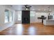 Open-concept living space with hardwood floors, a modern fireplace, kitchen, and large windows for natural light at 1120 Arlington Sw Ave, Atlanta, GA 30310