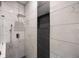 Detailed view of the shower featuring white marble-look and black tiled walls with shower niche at 1120 Arlington Sw Ave, Atlanta, GA 30310